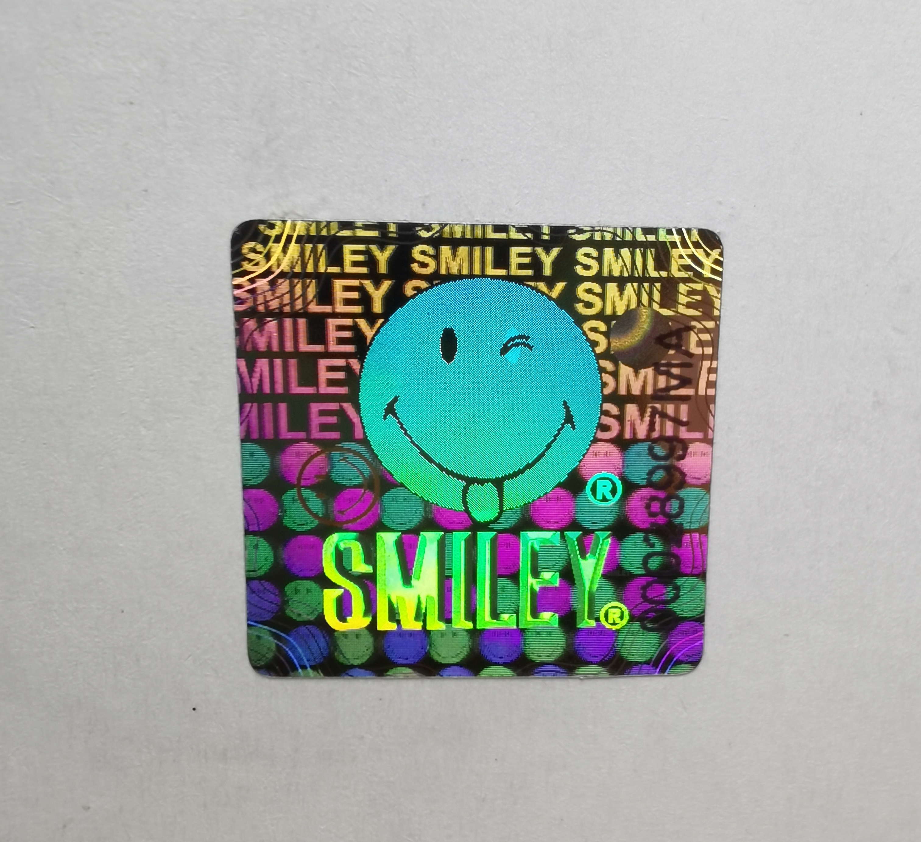 Smiley face holographic sticker serial number